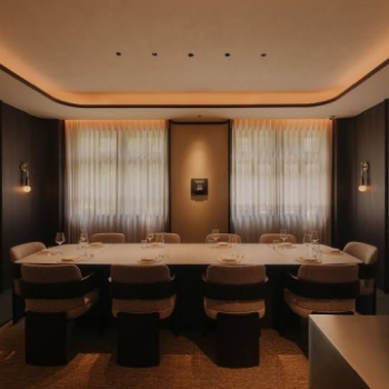 Interior dining area and elegant table setting at Michelin-starred restaurant Thevar in Singapore